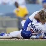Los Angeles Dodgers third baseman Justin Turner falls to the dirt after fouling the ball off of his leg against the Arizona Diamondbacks during the third inning of a baseball game, Monday, June 8, 2015, in Los Angeles. (AP Photo/Danny Moloshok)