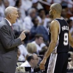 San Antonio Spurs head coach Gregg Popovich speaks to guard Tony Parker (9) during the first half in Game 3 of the NBA basketball finals against the Miami Heat, Tuesday, June 10, 2014, in Miami. (AP Photo/Wilfredo Lee)