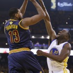 Cleveland Cavaliers center Tristan Thompson (13) shoots against Golden State Warriors forward Draymond Green (23) during the first half of Game 5 of basketball's NBA Finals in Oakland, Calif., Sunday, June 14, 2015. (AP Photo/Ben Margot)
