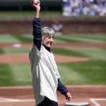 Sue Quigg, of Phoenix, and grandniece of former Chicago Cubs owner Charles Weeghman, walks out onto the field with a 100-year-old ball her grandmother Dessa Weeghman threw at a Chicago Federals game a century ago before the 100th anniversary of the first baseball game at Wrigley Field between the Arizona Diamondbacks and Cubs, Wednesday, April 23, 2014, in Chicago. (AP Photo/Charles Rex Arbogast)