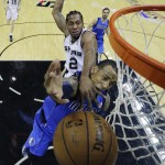  Dallas Mavericks' Monta Ellis, front, is fouled by San Antonio Spurs' Kawhi Leonard (2) as he tries to score during the first quarter of Game 1 of the opening-round NBA basketball playoff series, Sunday, April 20, 2014, in San Antonio. (AP Photo/Eric Gay)