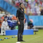 Germany's head coach Joachim Loew stands in the rain during the group G World Cup soccer match between the USA and Germany at the Arena Pernambuco in Recife, Brazil, Thursday, June 26, 2014. (AP Photo/Matthias Schrader)
