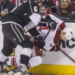  Los Angeles Kings defenseman Jake Muzzin (6) and Phoenix Coyotes forward Jeff Halpern (14) vie for the puck during the first period of an NHL hockey game, Wednesday, April 2, 2014, in Los Angeles. (AP Photo/Ringo H.W. Chiu)