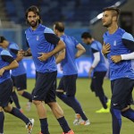 Greece's Giorgos Samaras, center left, warms up with teammates during a training session of Greece at Arena das Dunas in Natal, Brazil, Wednesday, June 18, 2014. Greece play in group C of the 2014 soccer World Cup. (AP Photo/Shuji Kajiyama)