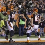 Cincinnati Bengals tight end Jermaine Gresham (84) celebrates after making a 2-yard touchdown reception during the first half of an NFL football game against the Denver Broncos Monday, Dec. 22, 2014, in Cincinnati. Ryan Hewitt is at right. (AP Photo/Michael Conroy)
