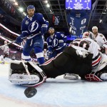 Tampa Bay Lightning right wing J.T. Brown, left, watches as Cedric Paquette's shot goes by Chicago Blackhawks goalie Corey Crawford during the first period in Game 2 of the NHL hockey Stanley Cup Final in Tampa, Fla., Saturday, June 6, 2015. (Bruce Bennett/Pool Photo via AP)