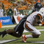 Oregon State wide receiver Victor Bolden (6) catches a pass for a touchdown while being defended by Hawaii defensive back Nick Nelson (20) in the third quarter of an NCAA college football game, Saturday, Sept. 6, 2014, in Honolulu. (AP Photo/Eugene Tanner)