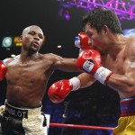 Floyd Mayweather Jr., left, lands a left against Manny Pacquiao, from the Philippines, during their welterweight title fight on Saturday, May 2, 2015 in Las Vegas. (AP Photo/John Locher)