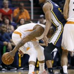 Phoenix Suns forward P.J. Tucker, left, runs into Utah Jazz guard Rodney Hood during the first half of an NBA basketball game, Saturday, April 4, 2015, in Phoenix. (AP Photo/Matt York)