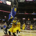 Golden State Warriors forward Draymond Green (23) goes up for a dunk over Cleveland Cavaliers guard Iman Shumpert (4) during the second half of Game 4 of basketball's NBA Finals in Cleveland, Thursday, June 11, 2015. The Warriors defeated the Cavaliers 103-82 to tie the best-of-seven game series at 2-2. (AP Photo/Paul Sancya, Pool)