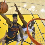 Cleveland Cavaliers guard Iman Shumpert (4) shoots against Golden State Warriors forward Draymond Green during the first half of Game 2 of basketball's NBA Finals in Oakland, Calif., Sunday, June 7, 2015. (Kyle Terada/USA TODAY Sports Pool via AP)