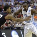North Carolina forward Theo Pinson, right, pushes his way around Harvard guard Wesley Saunders during the second half of an NCAA tournament second round college basketball game Thursday, March 19, 2015, in Jacksonville, Fla. (AP Photo/John Raoux)