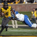 Missouri running back Marcus Murphy, left, spins away from the grasp of Kentucky's Adrian Middleton as he runs during the first quarter of an NCAA college football game Saturday, Nov. 1, 2014, in Columbia, Mo. (AP Photo/L.G. Patterson)