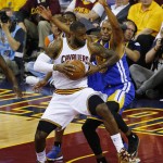 Cleveland Cavaliers forward LeBron James (23), left, drives on Golden State Warriors guard Andre Iguodala (9) during the first half of Game 6 of basketball's NBA Finals in Cleveland, Tuesday, June 16, 2015. (AP Photo/Paul Sancya)
