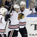 Chicago Blackhawks center Antoine Vermette (80) celebrates with left wing Teuvo Teravainen, center, and right wing Kris Versteeg (44) after Vermette scored a goal against the Tampa Bay Lightning during the third period of Game 5 of the NHL hockey Stanley Cup Final, Saturday, June 13, 2015, in Tampa, Fla. (AP Photo/John Raoux)