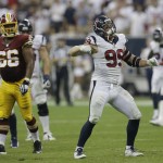 Houston Texans' J.J. Watt (99) celebrates after he sacked Washington Redskins' Robert Griffin III for a loss during the fourth quarter of an NFL football game Sunday, Sept. 7, 2014, in Houston. (AP Photo/David J. Phillip)
