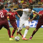  United States' Clint Dempsey, second from right, tries to push through Portugal's Ricardo Costa, right, and Portugal's Bruno Alves, let, during the group G World Cup soccer match between the United States and Portugal at the Arena da Amazonia in Manaus, Brazil, Sunday, June 22, 2014. (AP Photo/Marcio Jose Sanchez)