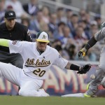 National League outfielder Andrew McCutchen, of the Pittsburgh Pirates, steals third base as American League Josh Donaldson, of the Oakland Athletics, tries to make the tag during the first inning of the MLB All-Star baseball game, Tuesday, July 15, 2014, in Minneapolis. (AP Photo/Jeff Roberson)