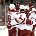 Members of the Phoenix Coyotes celebrate a goal by center Kyle Chipchura (24) during the first period of an NHL hockey game against the New Jersey Devils, Thursday, March 27, 2014, in Newark, N.J. (AP Photo/Julio Cortez)
