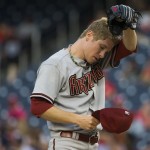 Arizona Diamondbacks starting pitcher Chase Anderson wipes away sweat during the first inning of a baseball game against the Washington Nationals on Tuesday, Aug. 19, 2014, in Washington. (AP Photo/Evan Vucci)