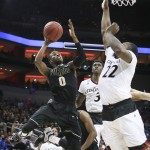 Purdue guard Jon Octeus is fouled on the way to the basket by Cincinnati center Coreontae DeBerry during the first half of an NCAA tournament second round college basketball game in Louisville, Ky., Thursday, March 19, 2015. (AP Photo/David Stephenson)