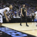 Cincinnati guard Troy Caupain, left, watches his game-tying basket against Purdue at the end of the second half of an NCAA tournament second round college basketball game in Louisville, Ky., Thursday, March 19, 2015. At right is Purdue center A.J. Hammons and Cincinnati forward Jermaine Sanders. Cincinnati won 66-65 in overtime. (AP Photo/David Stephenson)