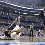 Florida guard Kasey Hill, left, falls to the court in front of Connecticut's Amida Brimah (35) and DeAndre Daniels (2) during the first half of an NCAA Final Four tournament college basketball semifinal game Saturday, April 5, 2014, in Arlington, Texas. (AP Photo/Eric Gay)
