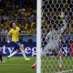 Germany's Andre Schuerrle, left, scores his side's seventh goal during the World Cup semifinal soccer match between Brazil and Germany at the Mineirao Stadium in Belo Horizonte, Brazil, Tuesday, July 8, 2014. (AP Photo/Matthias Schrader)