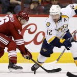 Nashville Predators' Mike Fisher (12) battles Arizona Coyotes' Mark Arcobello, left, for the puck during the first period of an NHL hockey game Monday, March 9, 2015, in Glendale, Ariz. (AP Photo/Ross D. Franklin)
