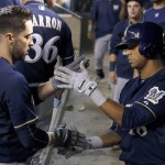 Milwaukee Brewers' Ryan Braun, left, celebrates his home run against the Arizona Diamondbacks with Khris Davis, right, during the sixth inning of a baseball game Friday, July 24, 2015, in Phoenix. (AP Photo/Ross D. Franklin)