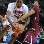Arizona forward Rondae Hollis-Jefferson, left, fights for the ball with Texas Southern forward Tonnie Collier during the first half in the second round of the NCAA college basketball tournament in Portland, Ore., Thursday, March 19, 2015. (AP Photo/Greg Wahl-Stephens)