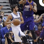 Minnesota Timberwolves' Ricky Rubio, left, of Spain, looks for help as Phoenix Suns' Markieff Morris hovers over him in the first quarter of an NBA basketball game, Friday, Feb. 20, 2015, in Minneapolis. Morris led the Suns with 31 points. The Timberwolves won 111-109. (AP Photo/Jim Mone)