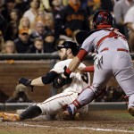 St. Louis Cardinals catcher Tony Cruz, right, tags out San Francisco Giants' Brandon Belt at home after he tried to score on a ball hit by Michael Morse during the seventh inning of Game 4 of the National League baseball championship series Wednesday, Oct. 15, 2014, in San Francisco. (AP Photo/David J. Phillip)