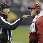 Arizona Cardinals head coach Bruce Arians, right, talks with an official in the first half of an NFL wild card playoff football game against the Carolina Panthers in Charlotte, N.C., Saturday, Jan. 3, 2015. (AP Photo/Bob Leverone)