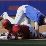  Arizona Diamondbacks' Martin Prado slides into third base with a RBI-triple as New York Mets third baseman David Wright takes the throw during the second inning of the second game of a baseball double-header Sunday, May 25, 2014, at Citi Field in New York. (AP Photo/Bill Kostroun)