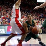 Utah Valley guard Marcel Davis (2), right, gets fouled by Arizona guard Elliott Pitts (24) during the first half of an NCAA college basketball game, Tuesday, Dec. 9, 2014, in Tucson, Ariz. (AP Photo/Rick Scuteri)