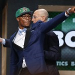 Oklahoma State's Marcus Smart, left, points to fans after being selected sixth overall by the Boston Celtics during the 2014 NBA draft, Thursday, June 26, 2014, in New York. (AP Photo/Jason DeCrow)