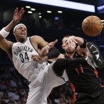 Brooklyn Nets' Paul Pierce, left, and Toronto Raptors' Jonas Valanciunas, vie for control of the ball during the first half of Game 3 of an NBA basketball first-round playoff series Friday, April 25, 2014, in New York. (AP Photo/Frank Franklin II)