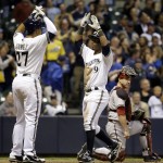  Milwaukee Brewers' Jean Segura celebrates with Carlos Gomez in front of Arizona Diamondbacks catcher Miguel Montero after Segura hit a two-run home run during the sixth inning of a baseball game Monday, May 5, 2014, in Milwaukee. (AP Photo/Morry Gash)
