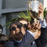 American Pharoah owner Ahmed Zayat holds the trophy after and after Victor Espinoza rode American Pharoah to victory in the 141st running of the Kentucky Derby horse race at Churchill Downs Saturday, May 2, 2015, in Louisville, Ky. (AP Photo/Garry Jones)