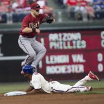 Philadelphia Phillies Ben Revere steals second base before Arizona Diamondbacks shortstop Chris Owings can make the tag in the first inning of a baseball game, Sunday, May 17, 2015, in Philadelphia. (AP Photo/Laurence Kesterson)