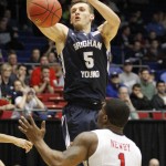 Brigham Young's Kyle Collinsworth (5) loses control of the ball against Mississippi's Martavious Newby (1) in the second half of a first round NCAA tournament gameTuesday, March 17, 2015 in Dayton, Ohio. (AP Photo/Skip Peterson)