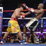 Manny Pacquiao, from the Philippines, left, trades blows with Floyd Mayweather Jr., during their welterweight title fight on Saturday, May 2, 2015 in Las Vegas. (AP Photo/John Locher)