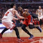 Washington Wizards guard John Wall, right, drives on Chicago Bulls guard Kirk Hinrich (12) during the first half of Game 2 in an opening-round NBA basketball playoff series Tuesday, April 22, 2014, in Chicago. (AP Photo/Charles Rex Arbogast)