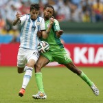  Argentina's Ricardo Alvarez, left, is tackled by Nigeria's Michael Uchebo during the group F World Cup soccer match between Nigeria and Argentina at the Estadio Beira-Rio in Porto Alegre, Brazil, Wednesday, June 25, 2014. (AP Photo/Victor R. Caivano)