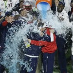 New England Patriots head coach Bill Belichick is dunked with water on the sidelines during the second half of NFL Super Bowl XLIX football game against the Seattle Seahawks Sunday, Feb. 1, 2015, in Glendale, Ariz. The Patriots won 28-24. (AP Photo/Charlie Riedel)