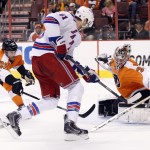 Philadelphia Flyers' Steve Mason, front right, looks to stop the shot by New York Rangers' Rick Nash, center, with Flyers' Mark Streit, left, of Switzerland, reaching for the puck with his stick during the second period in Game 4 of an NHL hockey first-round playoff series on Friday, April 25, 2014, in Philadelphia. (AP Photo/Chris Szagola)