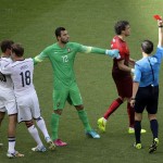 Referee Milorad Mazic from Serbia shows a red card to Portugal's Pepe after a scuffle with Germany's Thomas Mueller, right, as Portugal goalkeeper Eduardo, center, gestures during the group G World Cup soccer match between Germany and Portugal at the Arena Fonte Nova in Salvador, Brazil, Monday, June 16, 2014. (AP Photo/Christophe Ena)