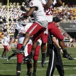 Washington State's Rickey Galvin (5) celebrates his touchdown with teammate Jamal Morrow (25) as quarterback Luke Falk, left, looks on during the first half of an NCAA college football game against Arizona State, Saturday, Nov. 22, 2014, in Tempe, Ariz. (AP Photo/Ross D. Franklin)