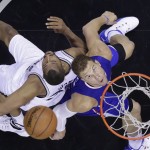 San Antonio Spurs' Boris Diaw, left, and Los Angeles Clippers' Blake Griffin, right, eye a rebound during the second half of Game 6 in an NBA basketball first-round playoff series, Friday, May 1, 2015, in San Antonio. Los Angeles won 102-96. (AP Photo/Darren Abate)